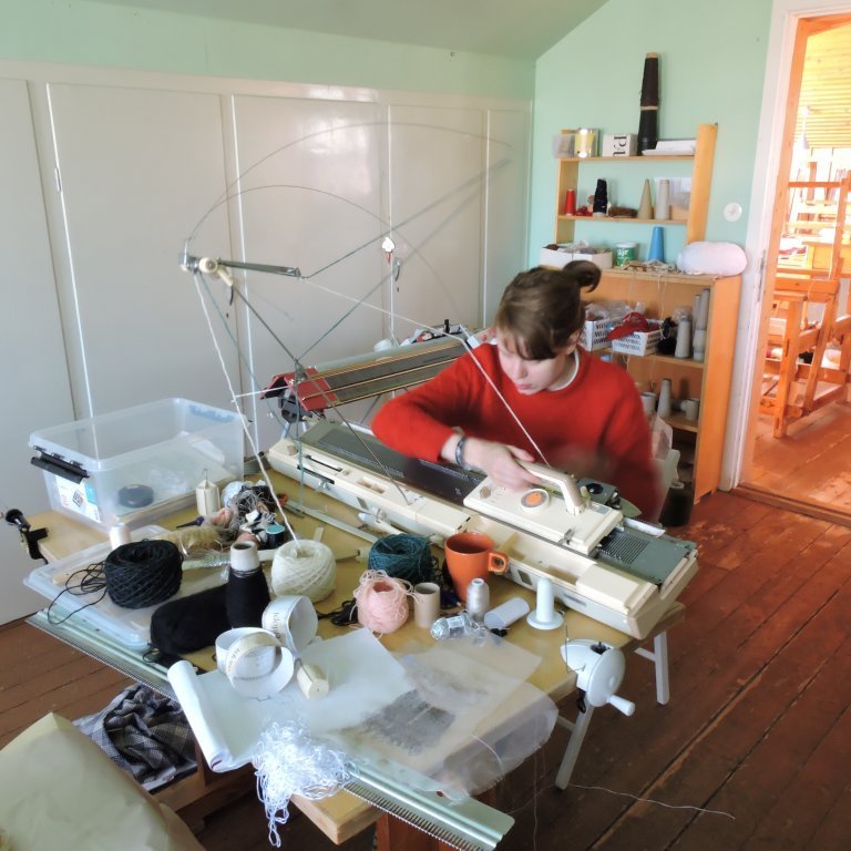 Artist in residence working on the knitting machine in the loom studio in 2018. Picture: Justine Sawicz.