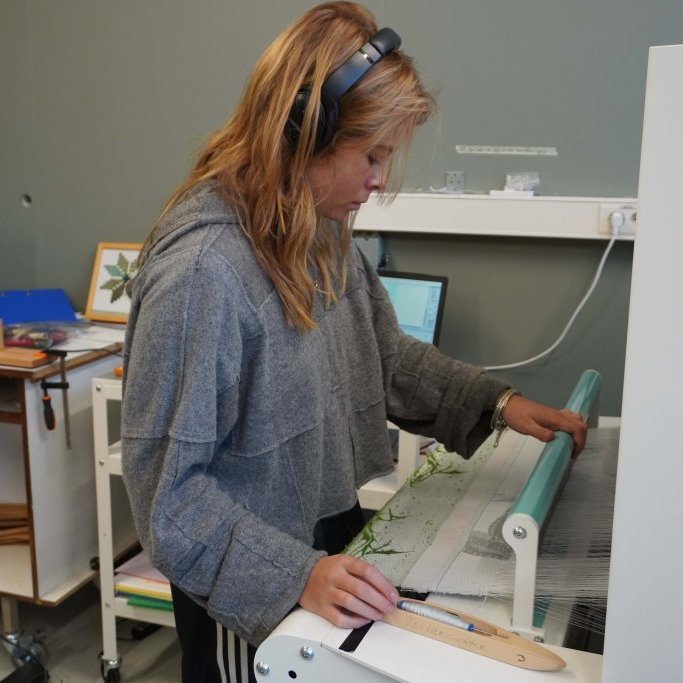 Students from Iceland University of the Arts working on the TC2 Digital Loom in 2024.  Image: Textile Center.